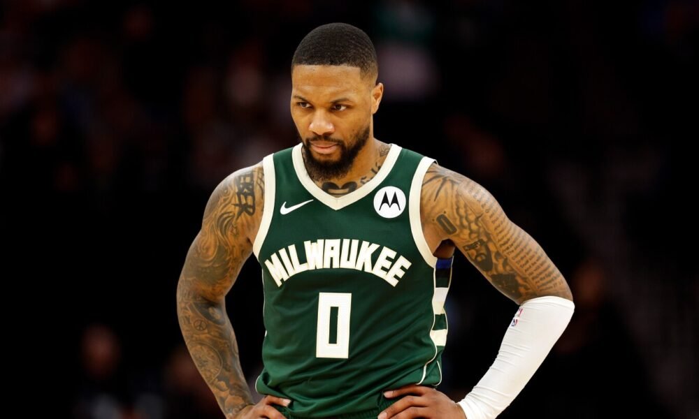 Damian Lillard, showcasing his signature "Dame Time" celebration during a Milwaukee Bucks game in the 2024-25 NBA season.