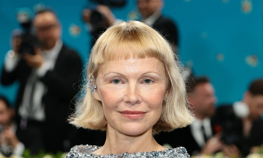 Pamela Anderson and son Brandon Thomas Lee grace the 2025 Met Gala — her fresh-faced look and baby bangs steal the show.