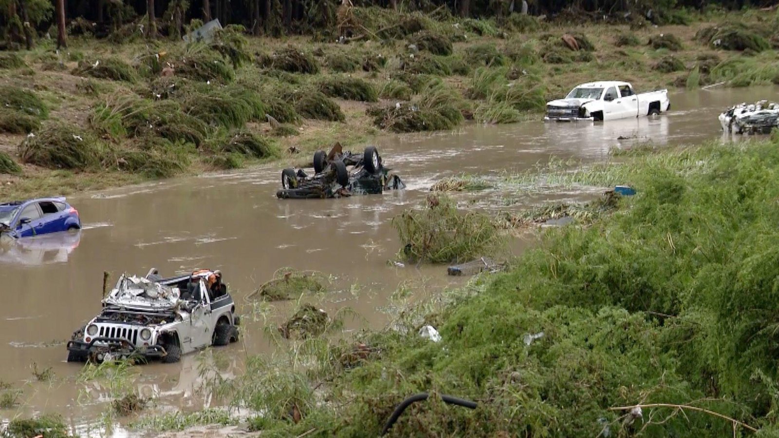 Rescue teams in San Antonio battle rising floodwaters as submerged vehicles mark the deadly aftermath of Thursday’s early morning floods.