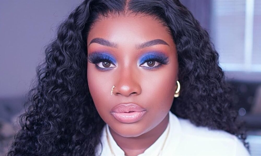 A model wears 2025’s biggest makeup statement: skyline eye design with blue lashes and blurred vinyl lips