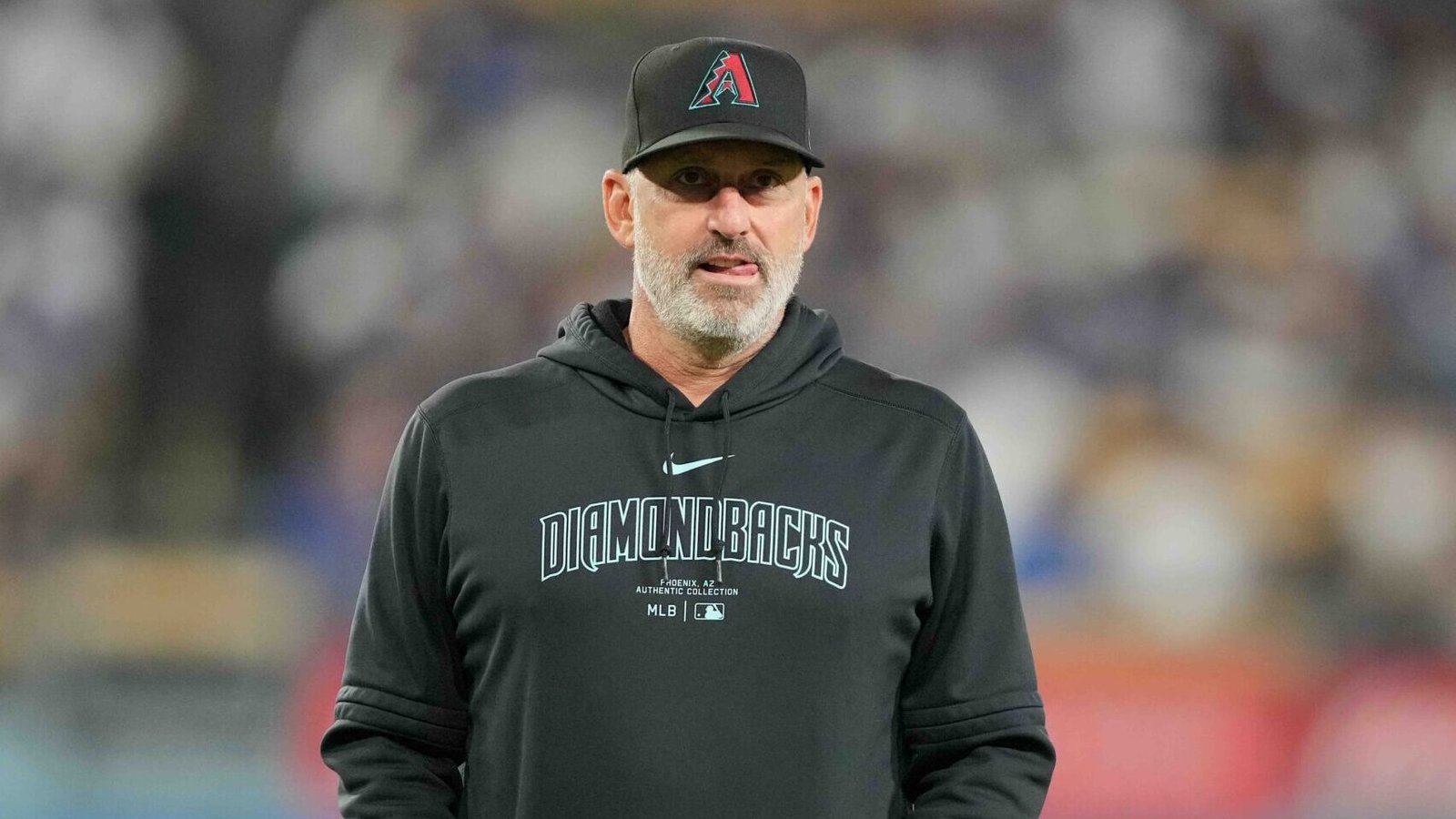 Torey Lovullo leading the Diamondbacks dugout—earning $5 million a year and turning Arizona into a contender.