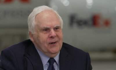 Frederick W. Smith, the force behind FedEx and Memphis’ global rise, pictured in front of a FedEx aircraft — the fleet that carried his vision across the world.