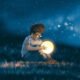 boy with a little moon in his hands