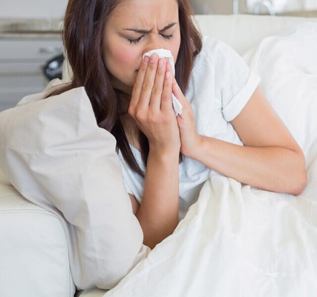 woman_lying_down_blowing_nose