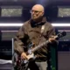 Paul “Bonehead” Arthurs, founding guitarist of Oasis, announced a temporary break from the band’s reunion tour to continue prostate cancer treatment, promising fans he’ll return “stronger than ever.”