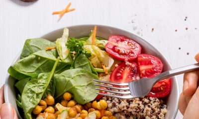 closeup_hand_with_quinoa_salad_1199279481