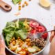 closeup_hand_with_quinoa_salad_1199279481