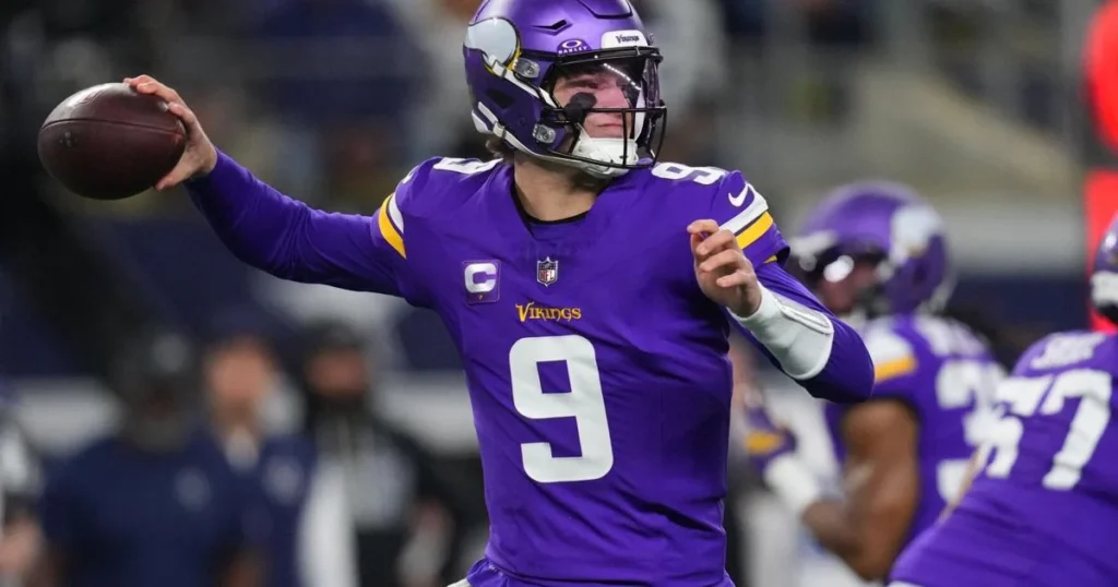 Vikings quarterback JJ McCarthy celebrates after throwing one of his two touchdown passes against the Cowboys