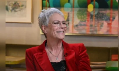 Person in red jacket, abstract background.