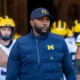 The University of Michigan athletic department faces renewed scrutiny following the firing of head football coach Sherrone Moore