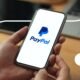PayPal logo on phone and laptop.