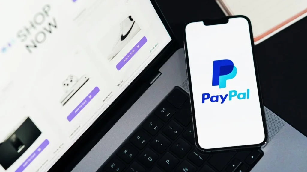 PayPal logo on phone and laptop.