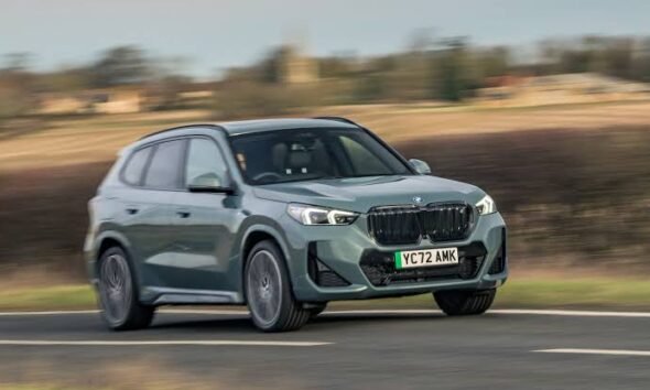 BMW SUV driving on a road
