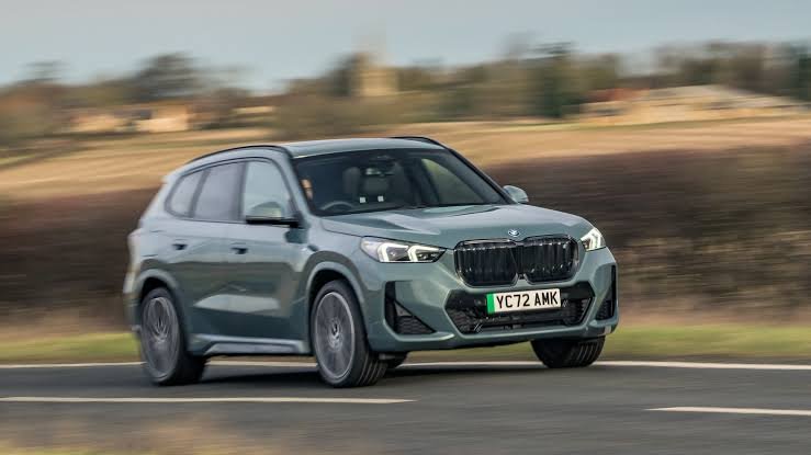 BMW SUV driving on a road